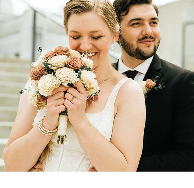 Bride and groom with sola wood flowers
