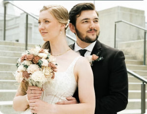 Sola wood boutonniere photographed at an outdoor ceremony