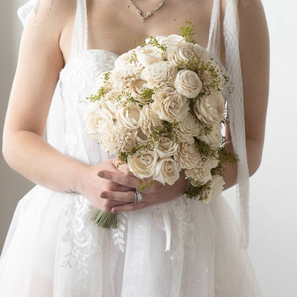Bride holding a Sola Wood Flowers bridal bouquet